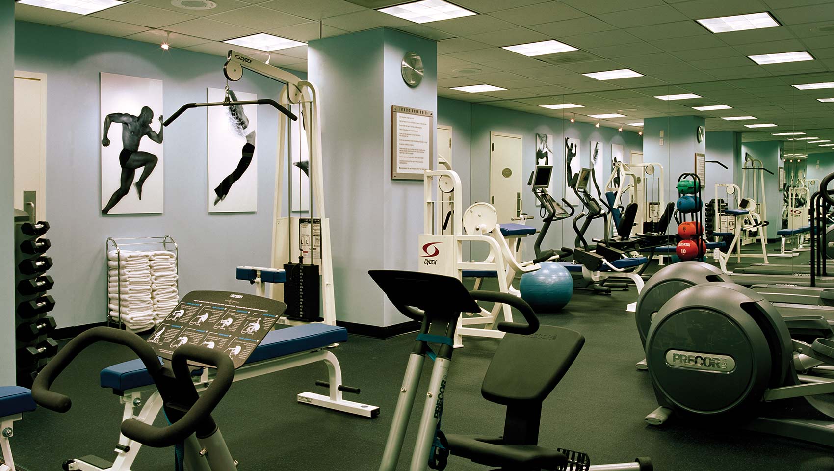 Fitness center with free weights, machines, exercise balls, and towels at Kimpton Hotel George