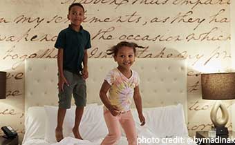 Kids playing on bed